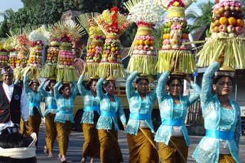 Bali Women carry offerings to the temple